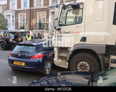 London.UK.16th April 2018.The driver and passenger of a small Volkswagen Scirocco had a lucky escape when they were hit broadside by a lorry coming down a one way system in Edith Grove in Chelsea, London. None of those involved seemed to be injured but witnesses say they heard the lorry’s horn and the squeal of it’s brakes for a good few seconds before the impact. © Brian Minkoff/Alamy Live News Stock Photo