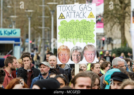 Bristol, UK. 16th April, 2018. Protesters carrying placards are pictured as they listen to speeches during a Stop Bombing Syria protest march and rally.  The rally and march was organised by the Bristol Stop the War Coalition to protest against the UK governments airstrikes in Syria. Credit: lynchpics/Alamy Live News Stock Photo