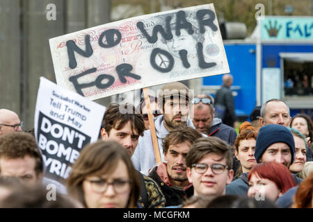 Bristol, UK. 16th April, 2018. Protesters carrying placards are pictured as they listen to speeches during a Stop Bombing Syria protest march and rally.  The rally and march was organised by the Bristol Stop the War Coalition to protest against the UK governments airstrikes in Syria. Credit: lynchpics/Alamy Live News Stock Photo