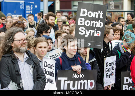 Bristol, UK. 16th April, 2018. Protesters carrying ‘Don’t bomb Syria’ placards are pictured as they listen to speeches during a Stop Bombing Syria protest march and rally.  The rally and march was organised by the Bristol Stop the War Coalition to protest against the UK governments airstrikes in Syria. Credit: lynchpics/Alamy Live News Stock Photo