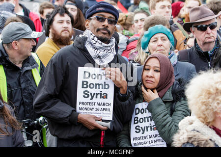 Bristol, UK. 16th April, 2018. Protesters carrying ‘Don’t bomb Syria’ placards are pictured as they listen to speeches during a Stop Bombing Syria protest march and rally.  The rally and march was organised by the Bristol Stop the War Coalition to protest against the UK governments airstrikes in Syria. Credit: lynchpics/Alamy Live News Stock Photo