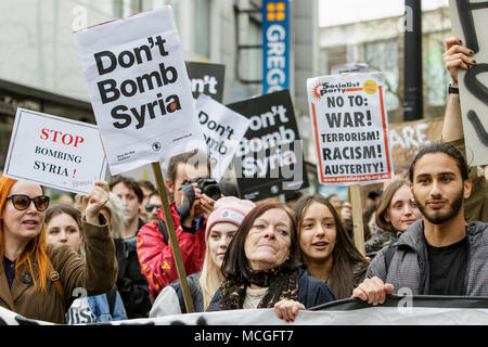 Bristol, UK. 16th April, 2018. Protesters carrying ‘Don’t bomb Syria’ placards are pictured as they march through Bristol during a Stop Bombing Syria protest march.  The rally and march was organised by the Bristol Stop the War Coalition to protest against the UK governments airstrikes in Syria. Credit: lynchpics/Alamy Live News Stock Photo