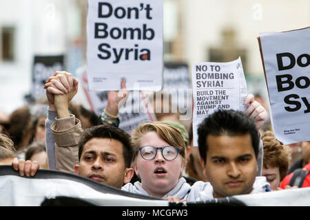 Bristol, UK. 16th April, 2018. Protesters carrying ‘Don’t bomb Syria’ placards are pictured as they march through Bristol during a Stop Bombing Syria protest march.  The rally and march was organised by the Bristol Stop the War Coalition to protest against the UK governments airstrikes in Syria. Credit: lynchpics/Alamy Live News Stock Photo