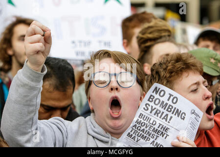 Bristol, UK. 16th April, 2018. Protesters are pictured as they march through Bristol during a Stop Bombing Syria protest march.  The rally and march was organised by the Bristol Stop the War Coalition to protest against the UK governments airstrikes in Syria. Credit: lynchpics/Alamy Live News Stock Photo