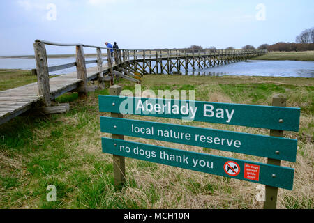 View of wooden footbridge leading to Aberlady Bay Nature Reserve on coast of Firth of Forth estuary in East Lothian, Scotland, UK Stock Photo