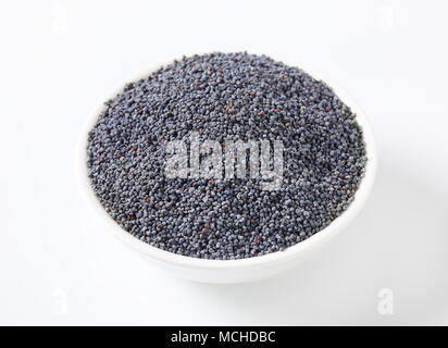 bowl of whole blue poppy seeds Stock Photo