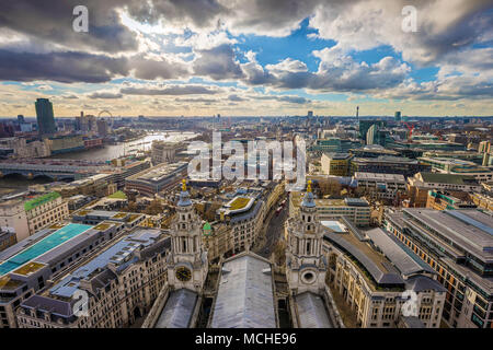 London, England - Panoramic skyline view of London taken from St. Paul's Cathedral with iconic red double-decker buses and beautiful sky and clouds Stock Photo
