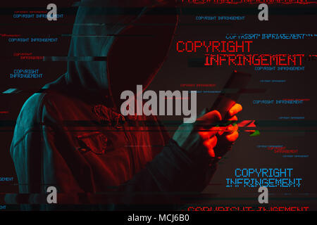 Criminal copyright infringement concept with faceless hooded male person, low key red and blue lit image and digital glitch effect Stock Photo