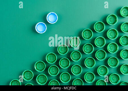 plastic green caps for pet bottles on a background Stock Photo