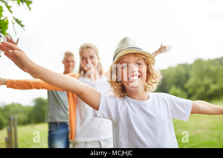 Boy is having fun while balancing on the trim. Path with the family Stock Photo