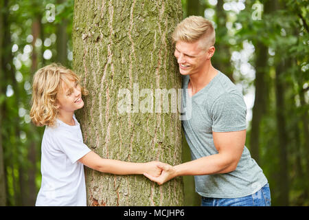 Father and son hold hands on a trip in the forest Stock Photo