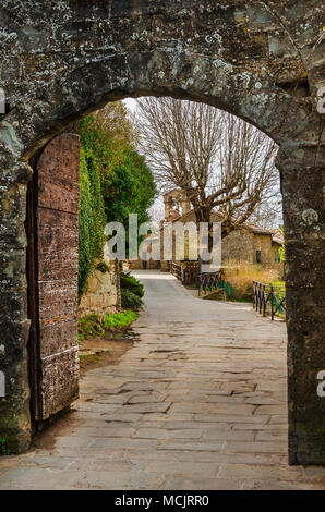Cortona medieval historic center seen through Porta Montanina ancient gate, in Tuscany Stock Photo