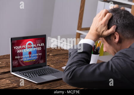 Close-up Of A Businessperson Looking At Laptop Screen Showing Personal Files Encrypted Text Stock Photo
