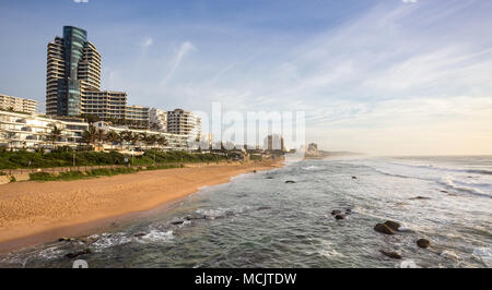 Durban, South Africa, April 9 - 2018: Seafront at dawn with holiday apartment buildings catching the sunlight. Stock Photo