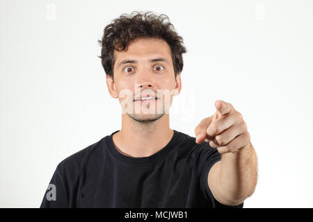Nice boy in black T-shirt pointing finger at camera Stock Photo