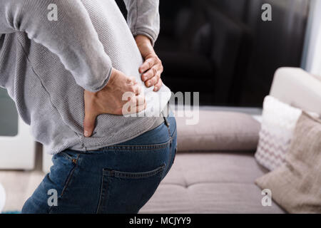 Mid Section View Of A Man Suffering From Back Pain Stock Photo