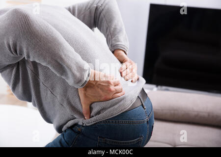 Mid Section View Of A Man Suffering From Back Pain Stock Photo
