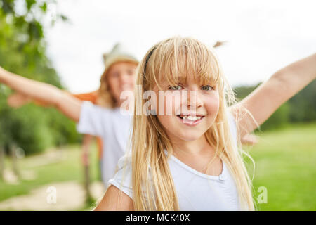 Blonde girl is having fun exercising on the trim you path Stock Photo