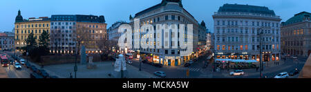 VIENNA, AUSTRIA - MARCH 19, 2018: Panoramic view of Helmut Zilk-Platz from Albertina in the evening, with Hotel Sacher and the State Opera on the righ Stock Photo