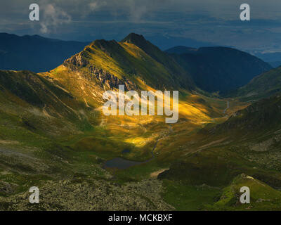 The picturesque landscape in the mountains with dramatic weather. Fagaras Mountains, Romania. Stock Photo