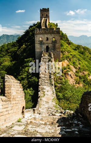 Closeup of Great Wall of China tower in mountains and green countryside Stock Photo
