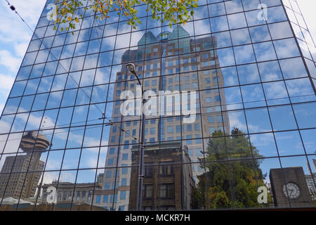 Reflections of an office tower and Vancouver Lookout in Hamilton Street, Vancouver downtown, Canada Stock Photo