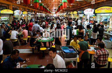 Singapore - January 21, 2014: A very busy hawker centre, where Singaporean people enjoy the variety of inexpensive food. Stock Photo