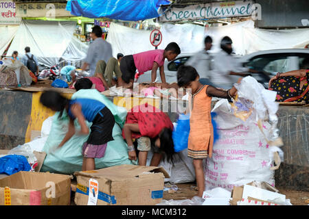 Street children working collecting cardboard and garbage in downtown Mumbai, India Stock Photo