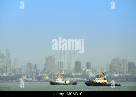 View of tug boats in Back Bay off Norman point with the skyscrapers of Colaba and modern Mumbai in the background. Port of Mumbai Stock Photo