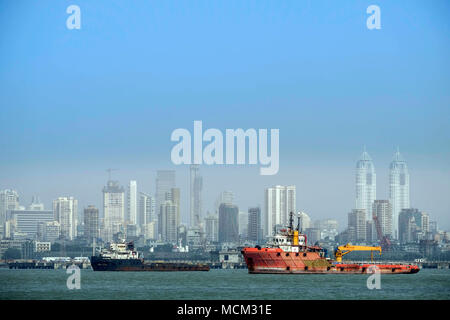 View of tug boats in Back Bay off Norman point with the skyscrapers of Colaba and modern Mumbai in the background. Port of Mumbai Stock Photo