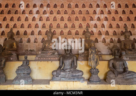 Front view of many old and aged Buddha statues at the Wat Si Saket (Sisaket) temple's cloister in Vientiane, Laos. Stock Photo