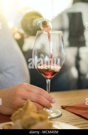 Pouring red wine from bottle into glass. Wine degustation. Stock Photo