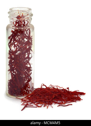 Closeup of Saffron in a bottle  used as food additive over white background Stock Photo