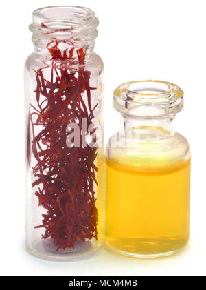 Closeup of Saffron in a bottle  used as food additive over white background Stock Photo