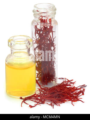 Closeup of Saffron in a bottle  used as food additive over white background Stock Photo