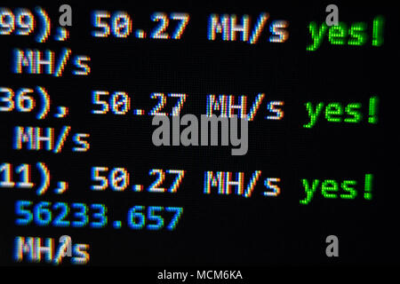 Close-up image of the computer s screen showing the blur of the programing code and a word BITCOIN for the concept of Stock Photo