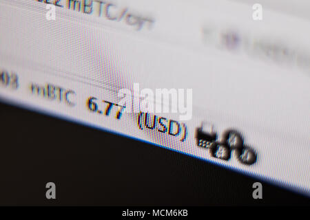 Close-up image of the computer s screen showing the blur of the programing code and a word BITCOIN for the concept of Stock Photo