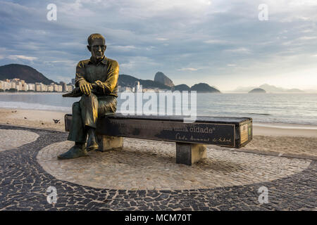 Statue of Carlos Drummond de Andrade (Brazilian poet) seen during sunrise in Copacabana Beach, Rio de Janeiro, Brazil Stock Photo