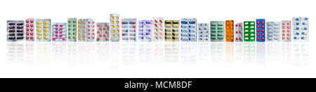 Many of colorful pills in blister packs in a row isolated on white background with copy space. Pharmaceuticals industry. Healthcare education in hospi Stock Photo