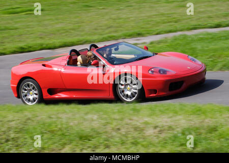 Red Ferrari 360 Spider super car sports car driving fast. Stock Photo