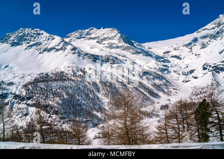 View of Alps covered with snow from the Bernina Express rail journey between St Moritz in Switzerland and Tirano in the north of Italy in march 25, 20 Stock Photo