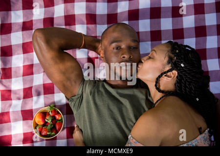 Couple lying in each others arms on a pinic blanket Stock Photo