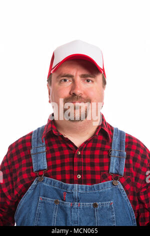 Male Workman in bib overalls, flannel shirt, and hat. Stock Photo