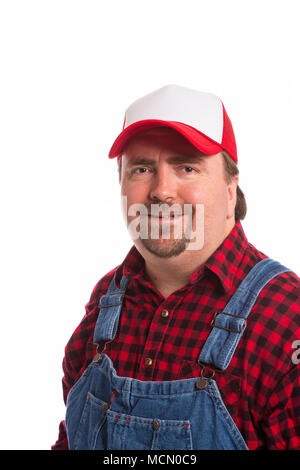 Male Workman in bib overalls, flannel shirt, and hat. Stock Photo