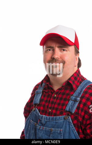 Male Workman in bib overalls, flannel shirt, and hat. Stock Photo