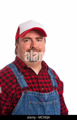 Male Workman in bib overalls, flannel shirt, and hat. Stock Photo