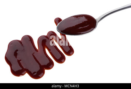 Barbecue sauce. Splashes and spilled grill sauce with spoon isolated on white background Stock Photo