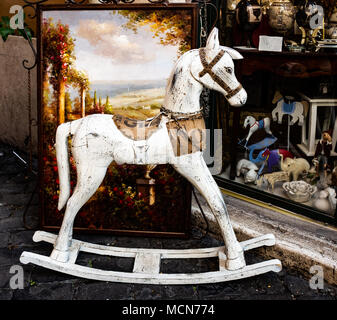 Vintage rocking horse in front of old toy shop Stock Photo
