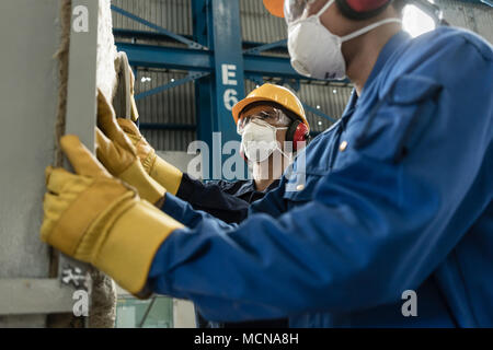 Two blue-collar workers wearing protective equipment  Stock Photo