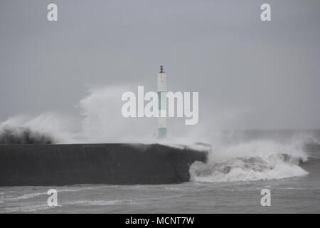 Aberystwyth, Ceredigion, Wales. 17th April 2018. UK Weather:  Gale force winds at high tide drive giant waves from a rough sea & smash into the harbour & promenade Flood warnings have been issued along the Welsh coast with a few warm sunny days to follow Credit: mike davies/Alamy Live News Stock Photo